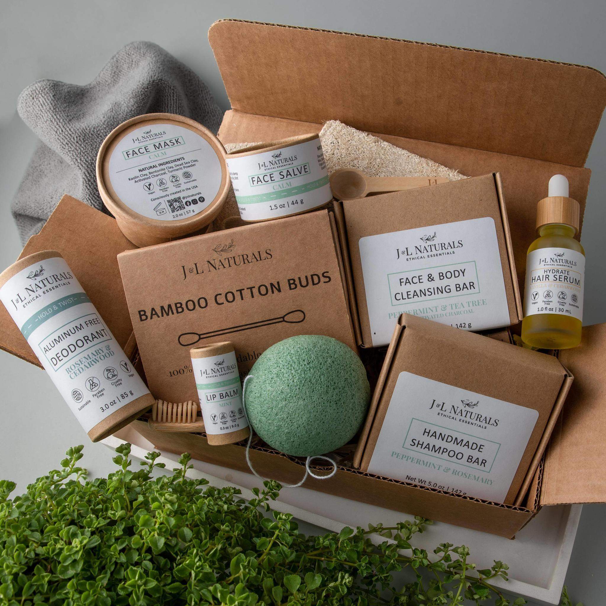 A beautifully arranged Advanced Self-Care Kit displayed in eco-friendly packaging with sustainable skincare and hygiene products surrounded by greenery.