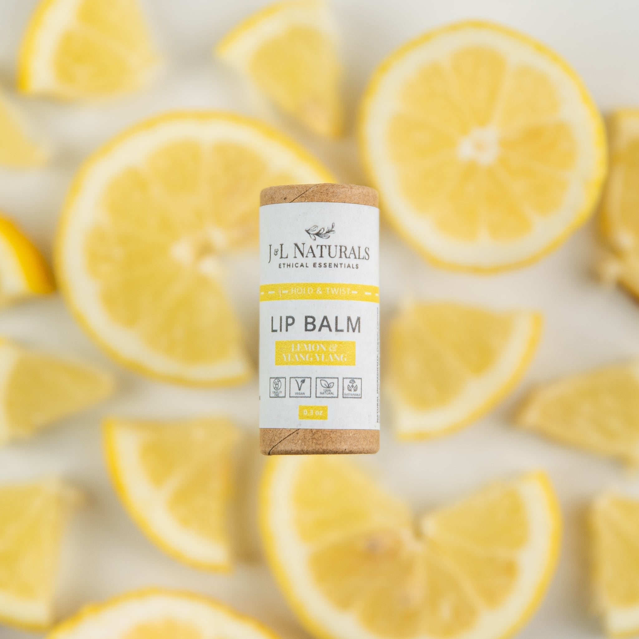  Lip balm sticks displayed with sliced lemons