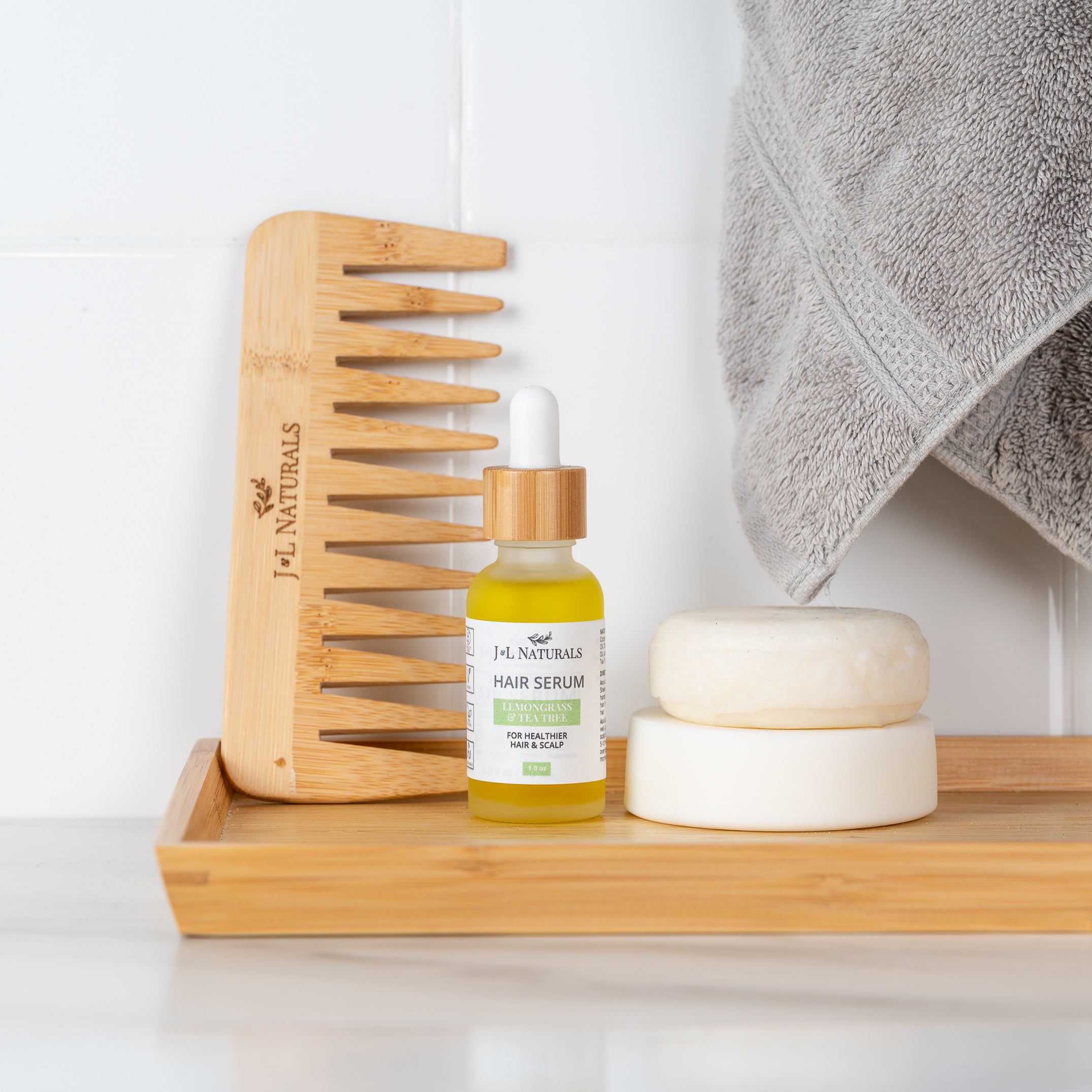 beauty kit items on a shelf with grey towel and background