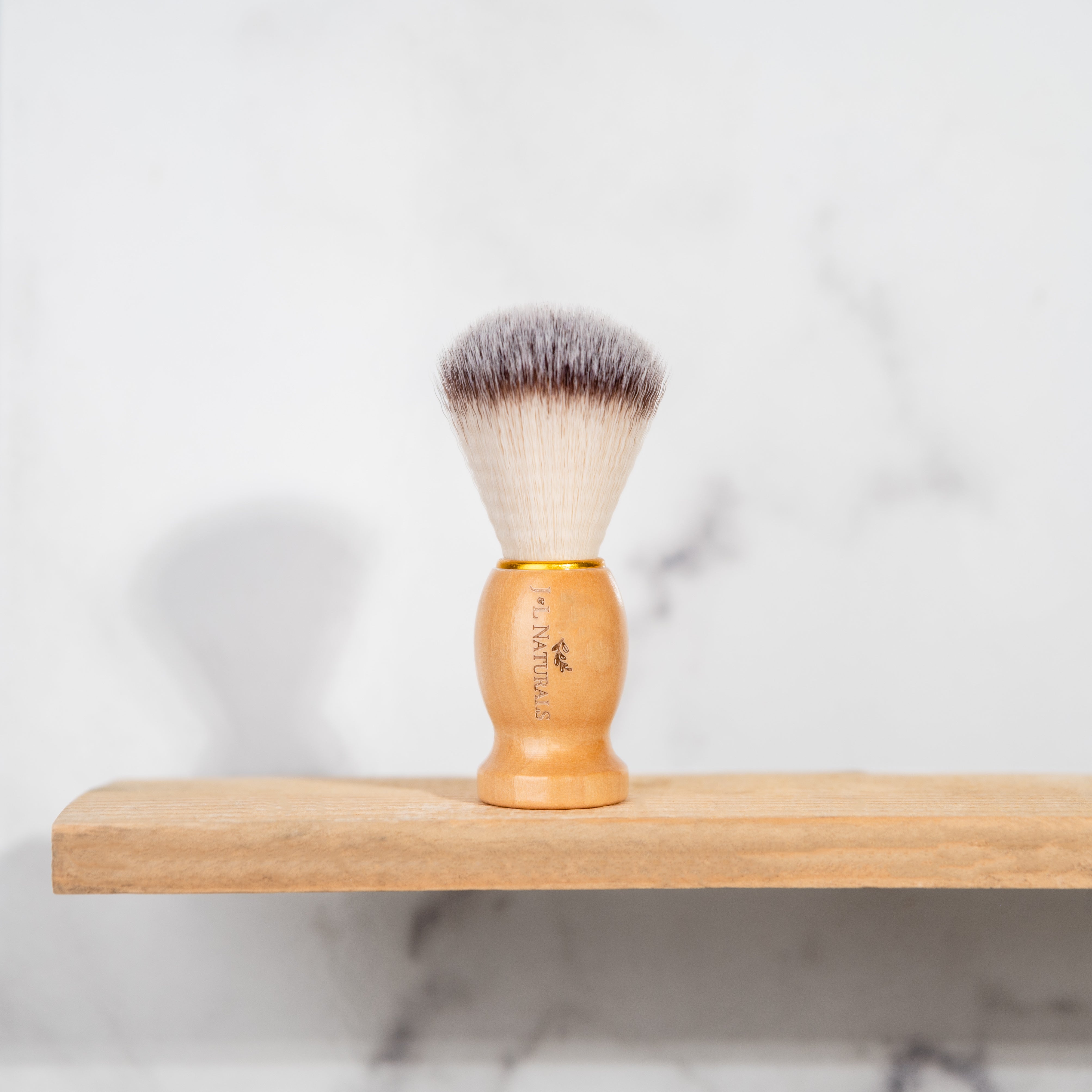 shave brush on wood shelf with white background