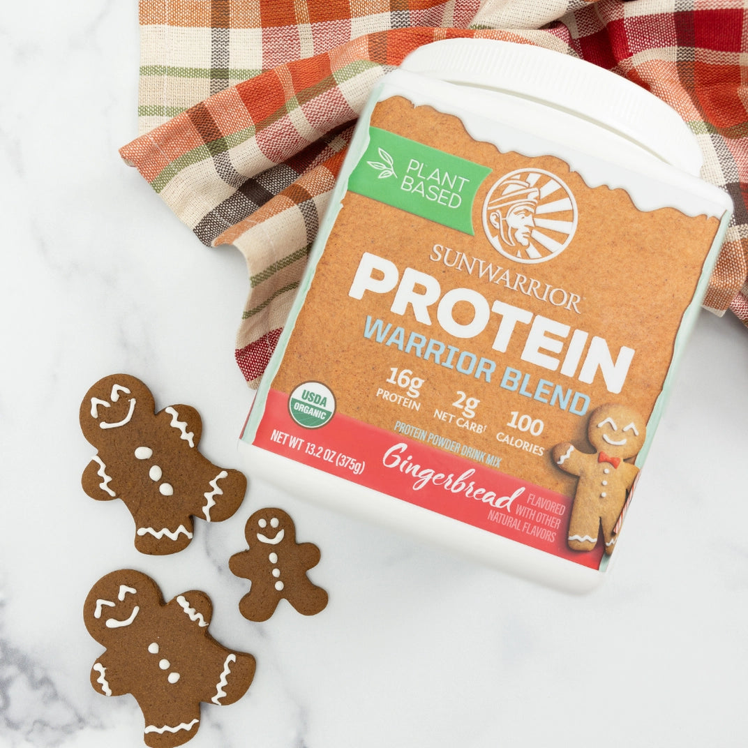 protein blend container, plaid blanket and gingerbread men on marble counter