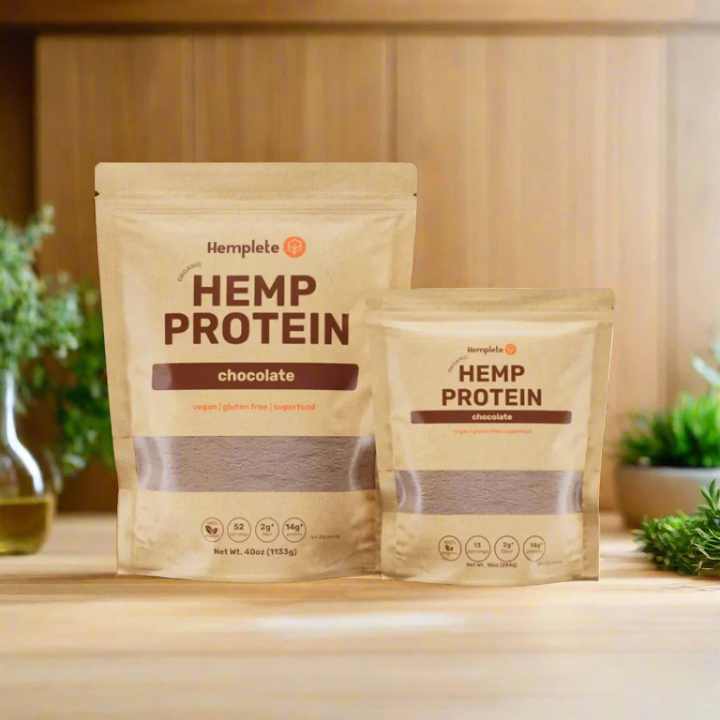 Plant-based protein powder with chocolate flavor on counter with wood back and plants around