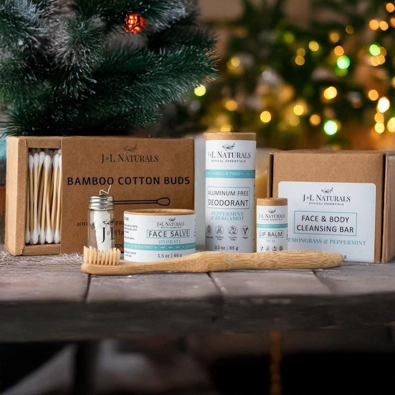 products displayed on table, pine branch and lights behind