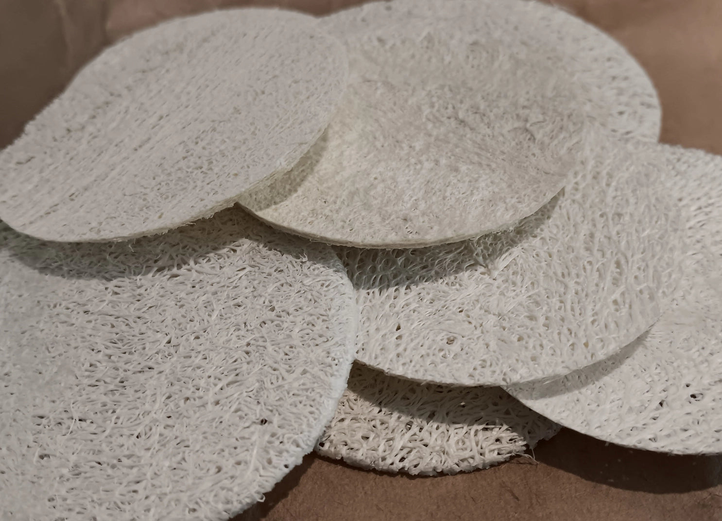 pile of loofahs on wooden surface