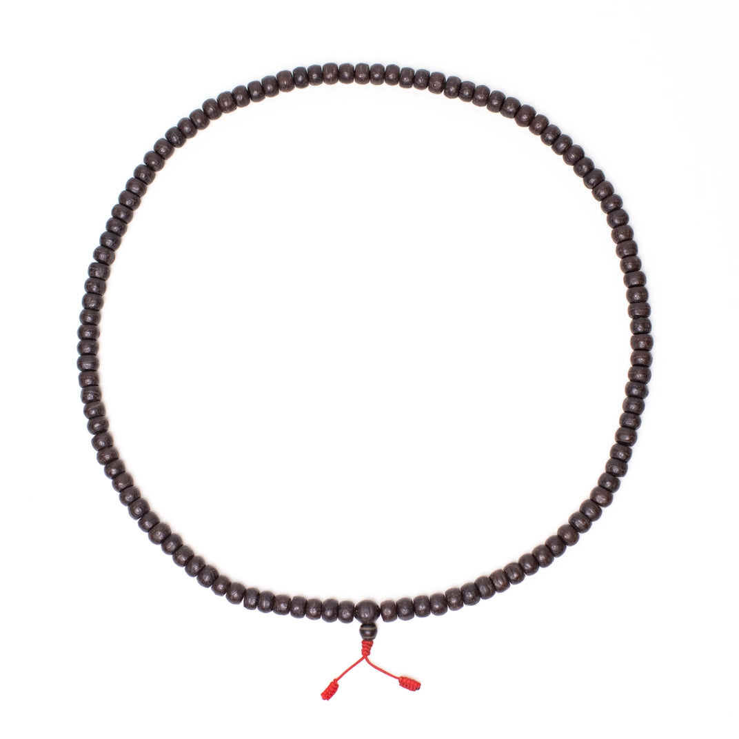 strand of beads circled white background