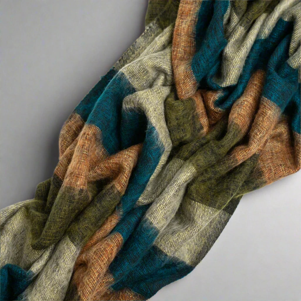 Scrunched yak wool blanket with earth tone stripes.